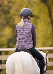 Back view of a model wearing Elderberry / Thistle Horse Kerrits Kids Pony Parade Reversible Quilted Vest showing the Thistle Horse reversible side