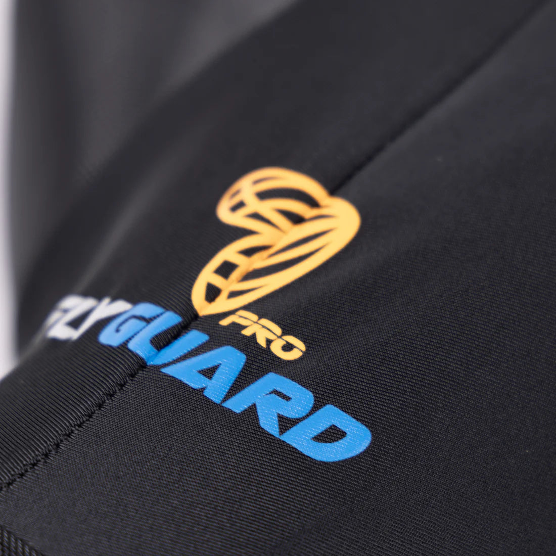 Close-up view of the orange and blue FlyGuard Pro Logo on the Shires FlyGuard Pro Stretch Fly Mask in black
