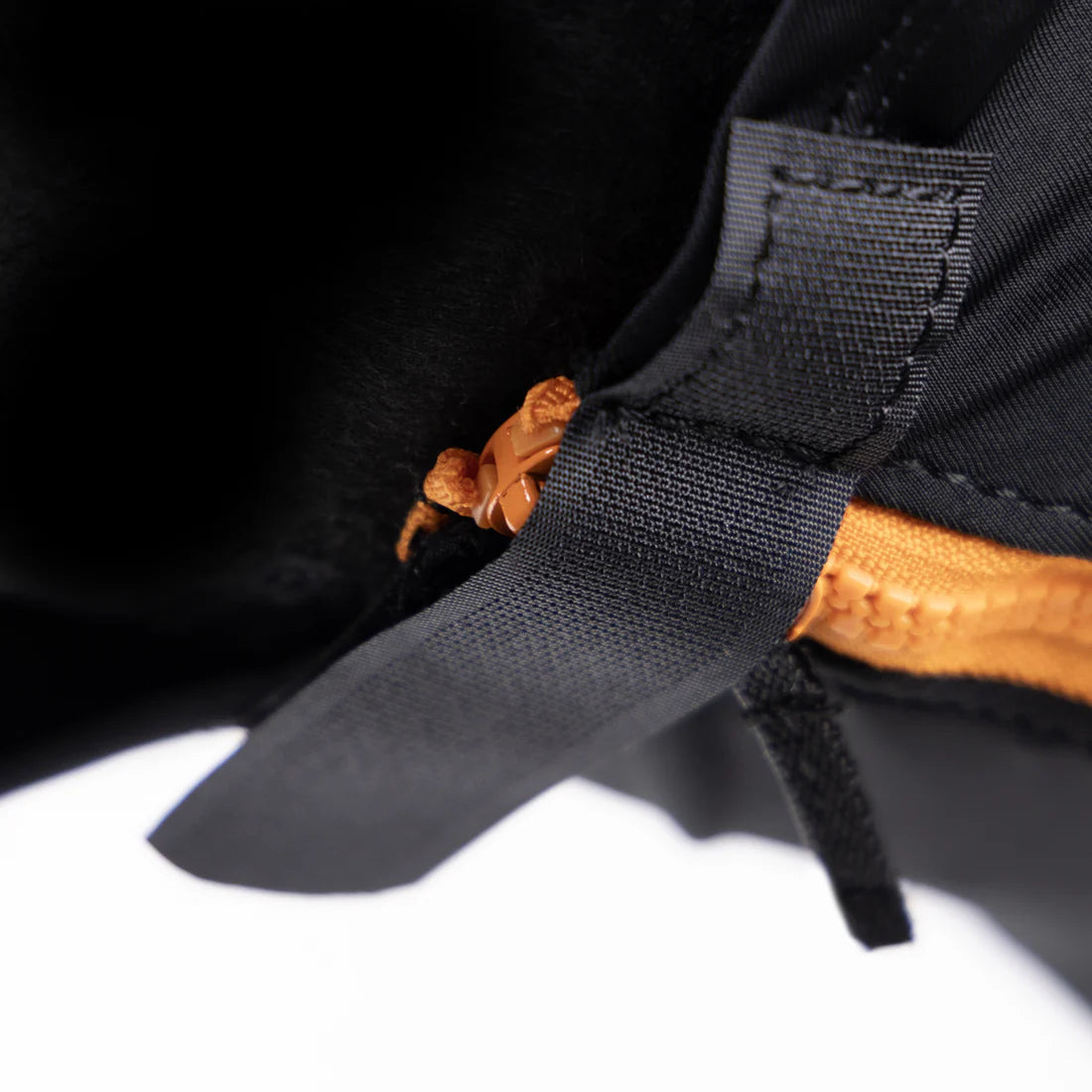 Close up view of the underside orange zip and black velcro closure on the Shires FlyGuard Pro Stretch Fly Mask in black