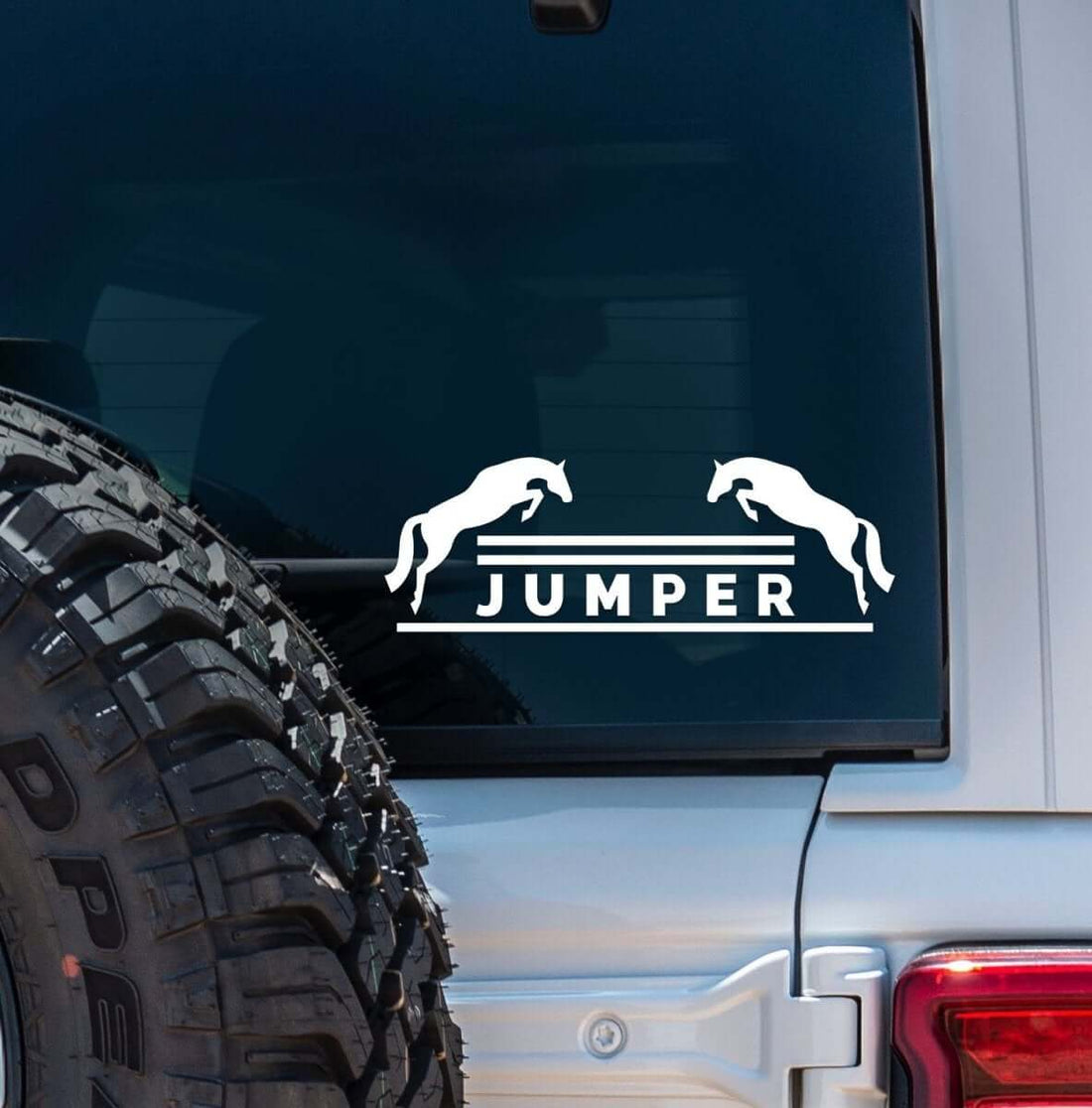 View of the white jumper Dapplebay Vinyl Decal on the back of a silver jeep