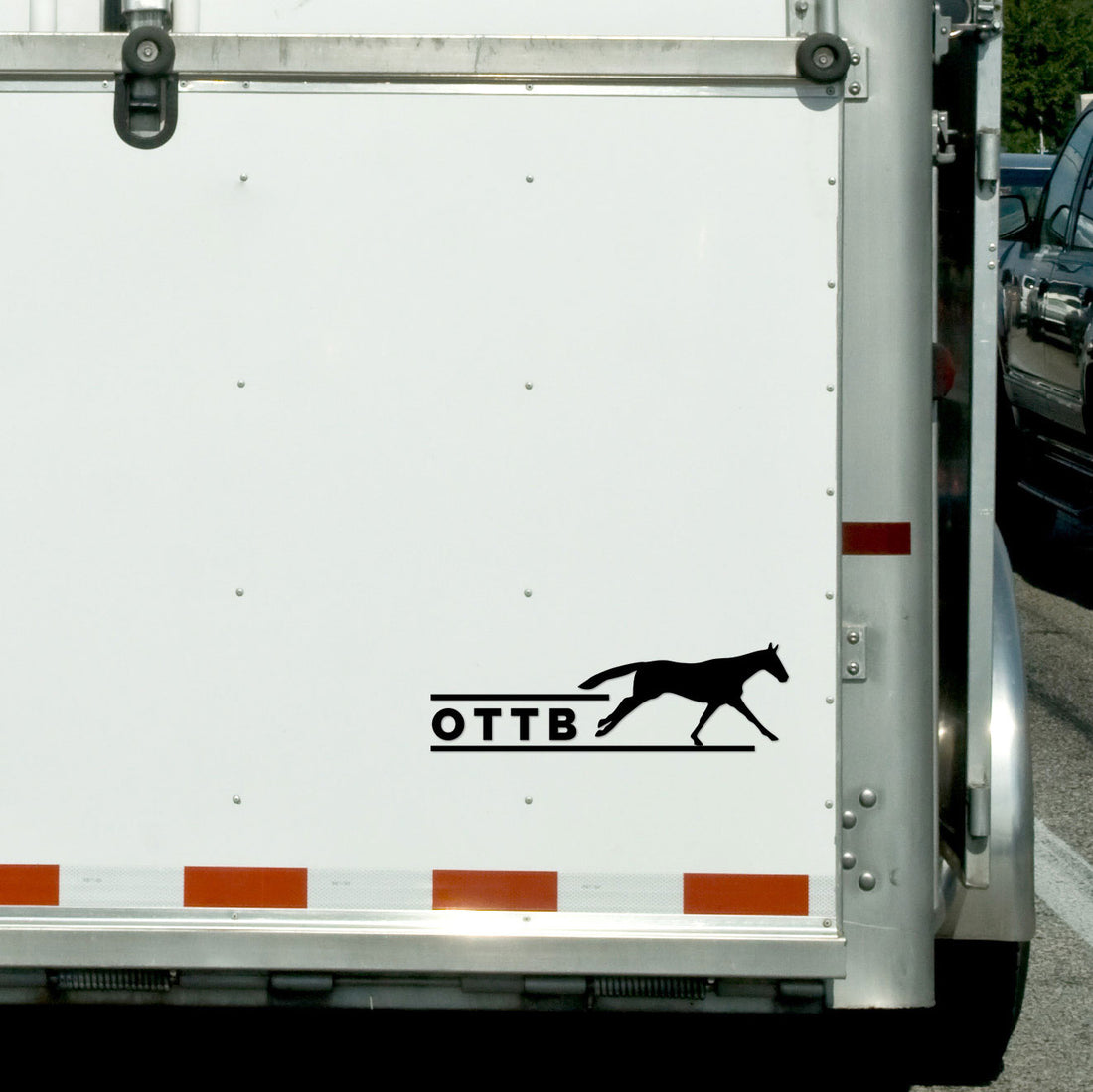 View of the black OTTB Dapplebay Vinyl Decal on the back of a horse trailer
