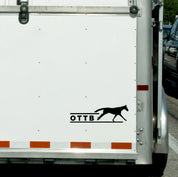 View of the black OTTB Dapplebay Vinyl Decal on the back of a horse trailer