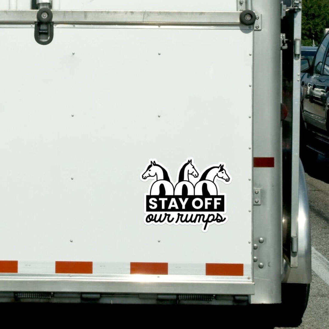 View of the Stay Off Our Rumps! Dapplebay Vinyl Trailer Decal on the back of a horse trailer