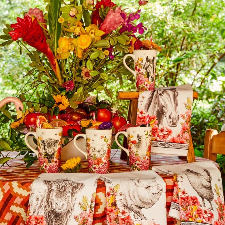 View of the Blue Stallion Farm Floral Bouquet collection on a vibrant table display including the Blue Stallion Farm Rocky Travel Mug