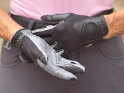 Close-up of a person wearing a pair of Correct Connect Oil-Tac Copper Tech™ Leather Premium Riding Gloves in black