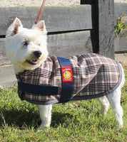 Side view of a Westie Terrier wearing the 5/A Baker Dog Blanket while standing outside