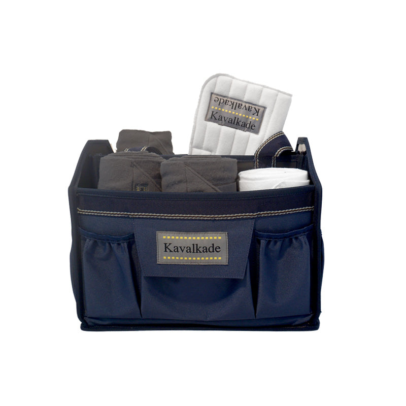 Front view of the navy Kavalkade Cleaning Bag with horse leg wraps inside on a white background