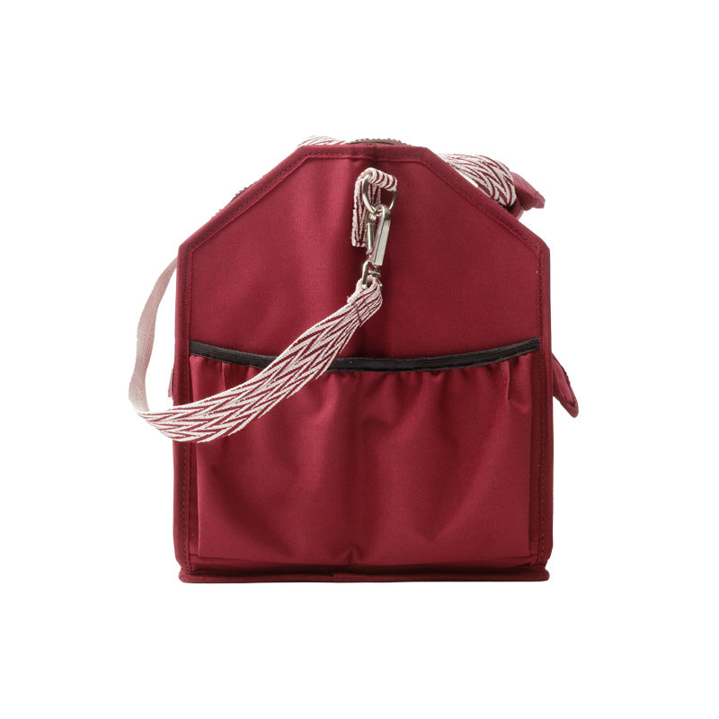 Side view of the red Kavalkade Cleaning Bag on a white background