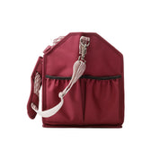 Side view of the red Kavalkade Cleaning Bag on a white background