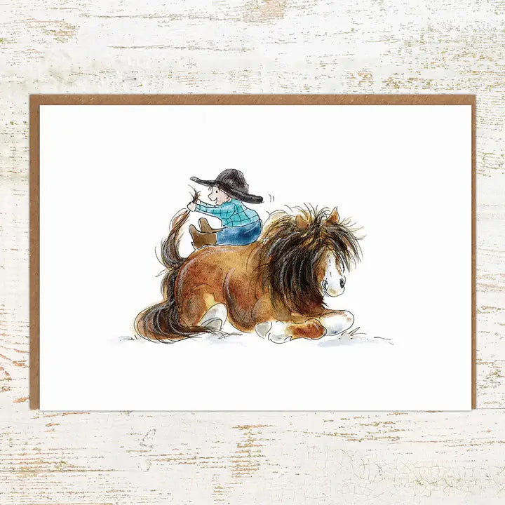 View of the Pony Up Pony Nut Greeting Card on a white washed wood background