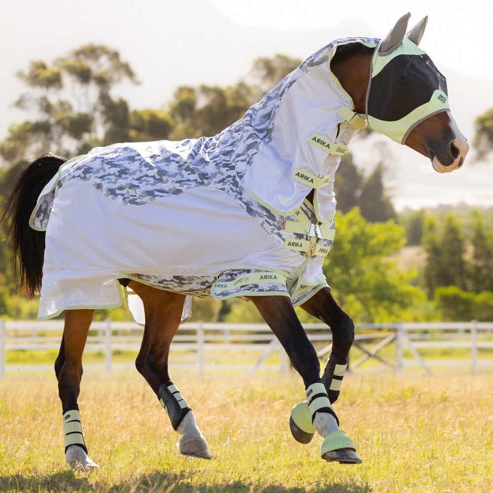 Side view of a horse cantering in a field wearing the LeMieux Arika Camo-Tek Fly Rug