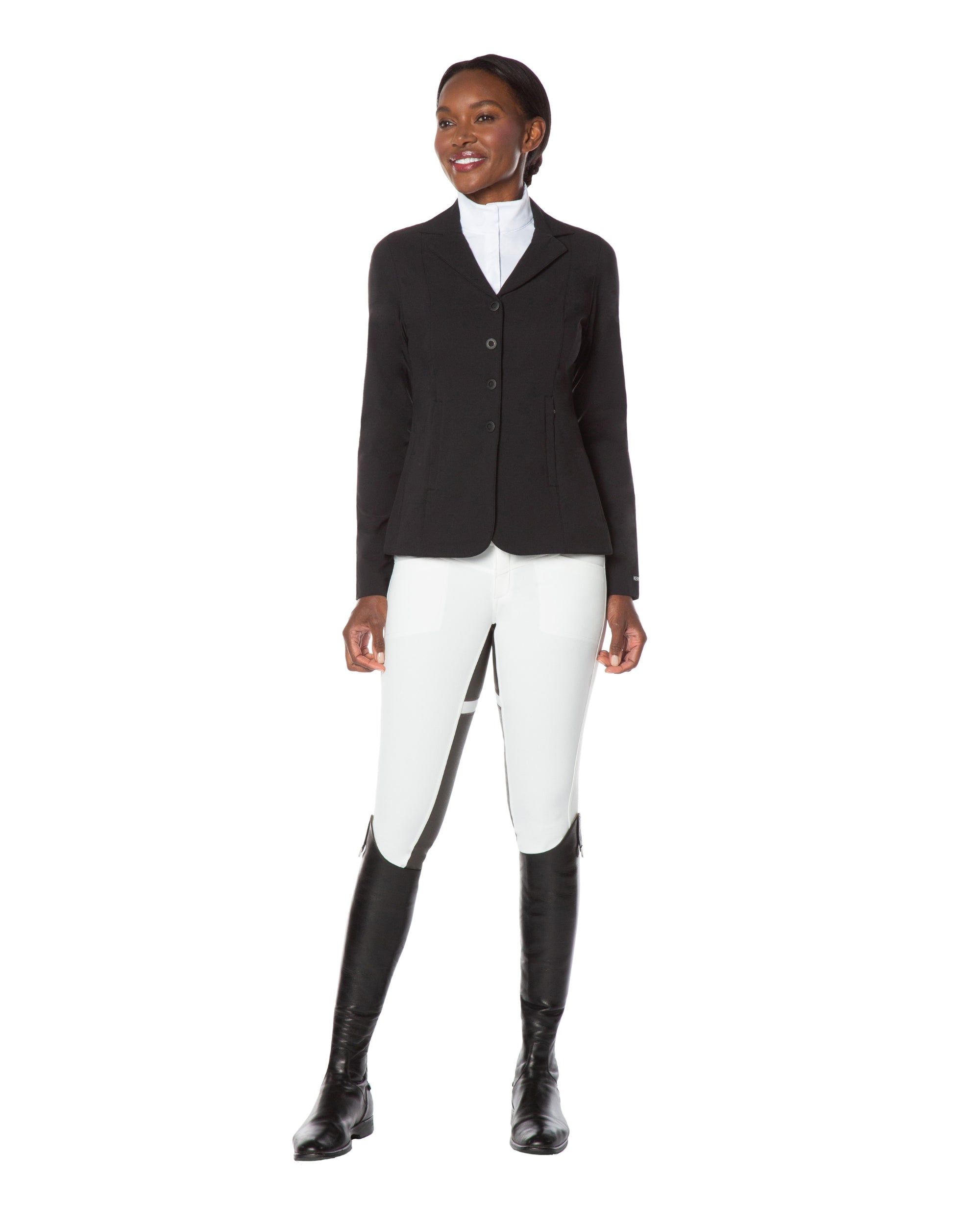 Full body front view of a female model wearing the white Kerrits Crossover II Full Seat Breech with black show coat on a white background