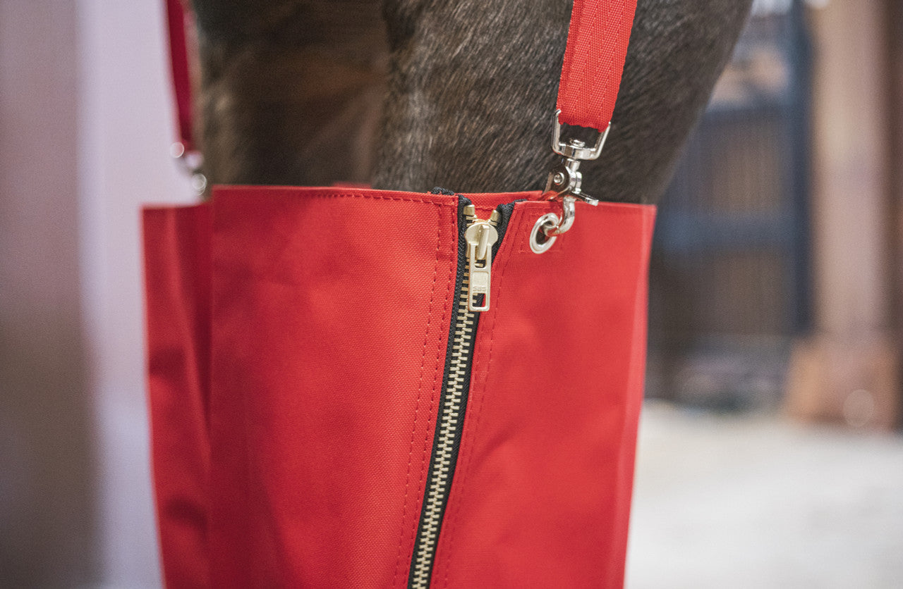 Close-up view of the zipper on the Cordura Ice Boots in red