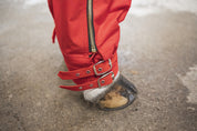 Close-up view of the adjustable buckles on the Cordura Ice Boots in red