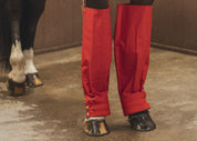 Close-up view of a horse wearing the the Cordura Ice Boots in red
