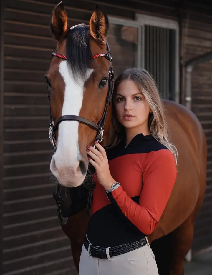 red Criniere Sophie Fierce Focus Long Sleeve Shirt with a barn in the background