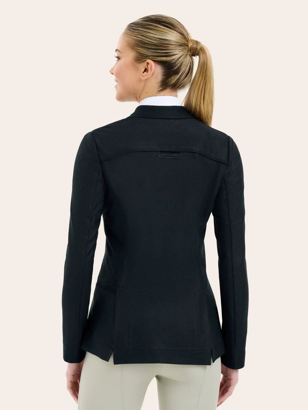 Back view of a female model wearing the black RJ Classic Addison Air Mesh Coat on a plain background