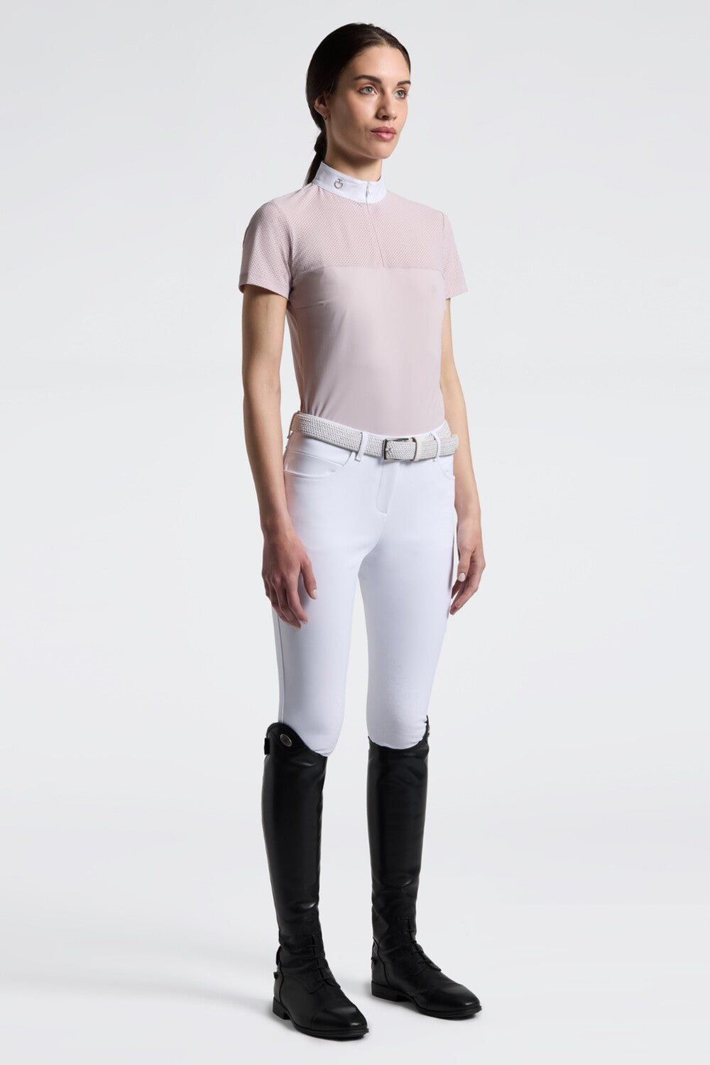 Full body front view of a model wearing the pink Cavalleria Toscana Perforated Short Sleeve Competition Shirt and white breeches on a plain background
