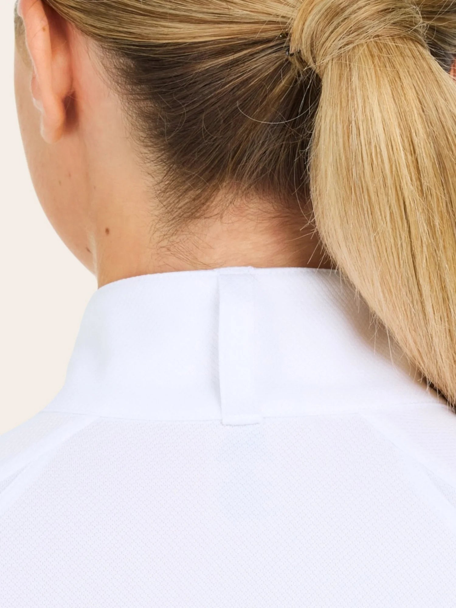 Close-up back view of a female model wearing the white RJ Classics Sofia Long Sleeve Show Shirt on a plain background
