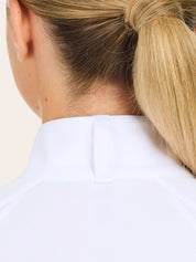 Close-up back view of a female model wearing the white RJ Classics Sofia Long Sleeve Show Shirt on a plain background