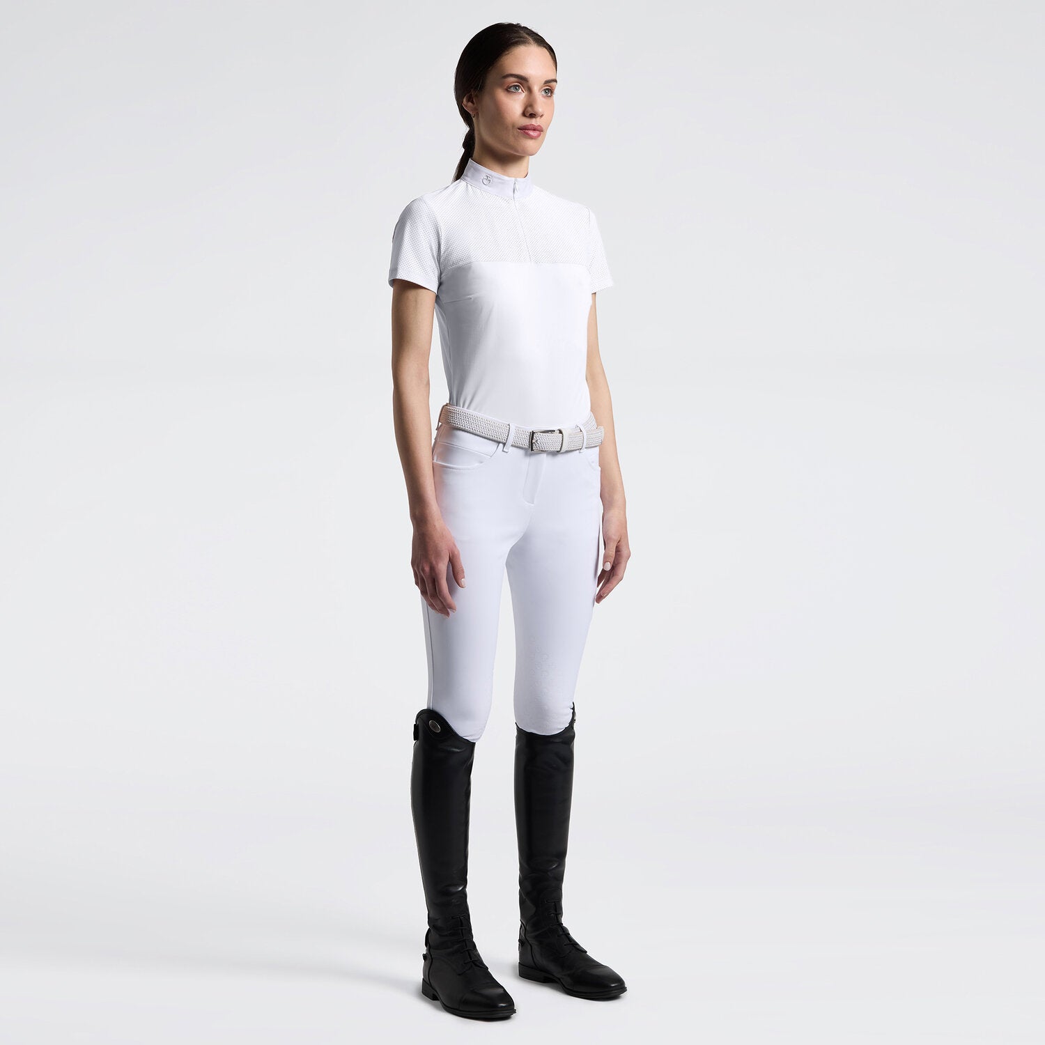 Full body front view of a model wearing the white Cavalleria Toscana Perforated Short Sleeve Competition Shirt and white breeches on a plain background