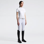 Full body front view of a model wearing the white Cavalleria Toscana Perforated Short Sleeve Competition Shirt and white breeches on a plain background