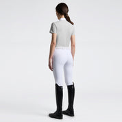 Full body back view of a model wearing the gray Cavalleria Toscana Perforated Short Sleeve Competition Shirt and white breeches on a plain background