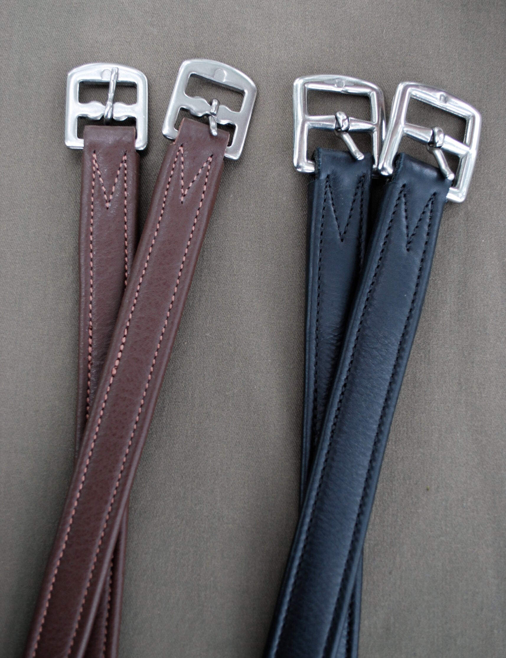 Side-by-side views of a pair of brown and a pair of black Red Barn Calf Lined Leathers on a gray background