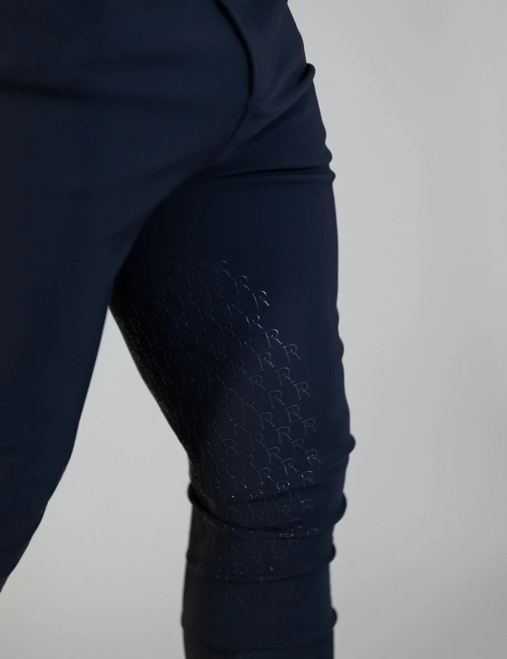Close-up view of a of the silicone grip on the navy Free Ride Men's PRO Knee Patch Breeches on a plain background