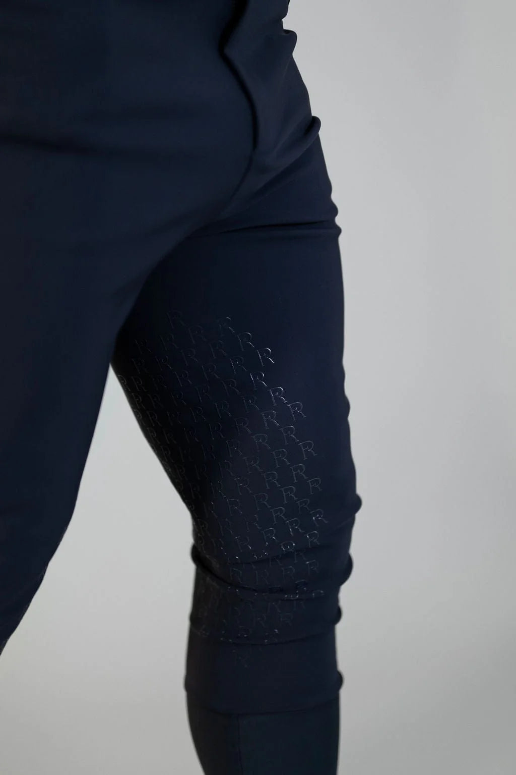 Close-up view of a of the silicone grip on the navy Free Ride Men's PRO Knee Patch Breeches on a plain background