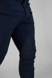 Close-up view of a of the silicone grip on the navy Free Ride Men's PRO Knee Patch Breeches on a plain background