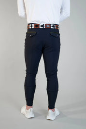 Back view of a male model wearing the navy Free Ride Men's PRO Knee Patch Breeches on a plain background