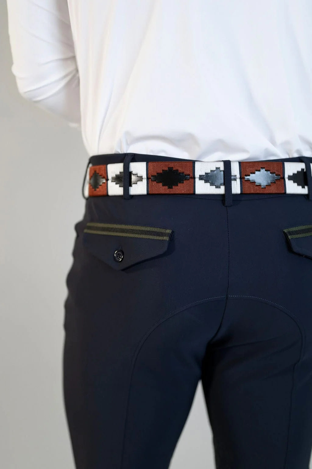 Close-up back view of a male model wearing the navy Free Ride Men's PRO Knee Patch Breeches on a plain background