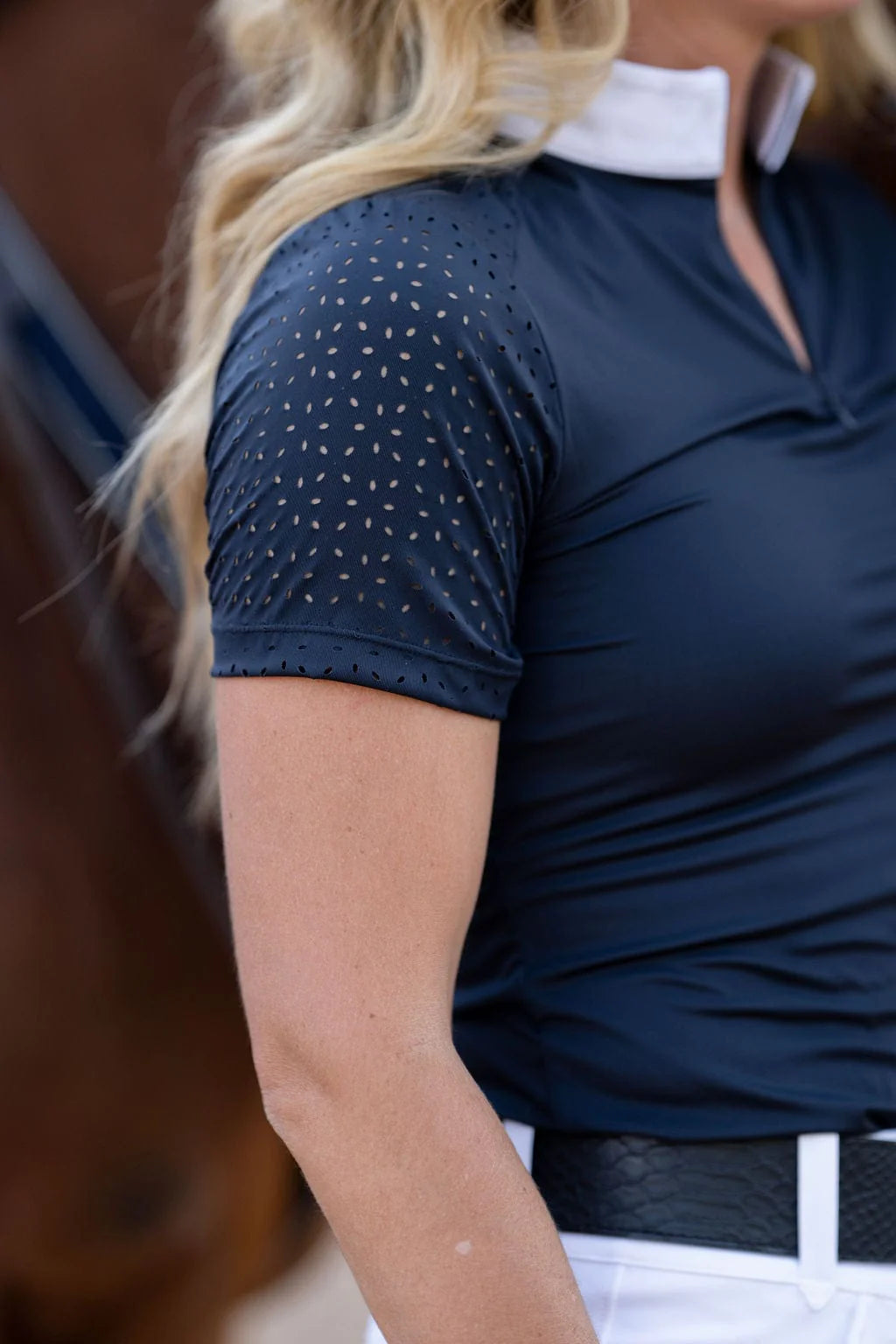 Close-up view of the laser cut perforations on the sleeve of the navy Free Ride Cassidy Short Sleeve Show Shirt