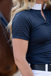 Close-up view of the laser cut perforations on the sleeve of the navy Free Ride Cassidy Short Sleeve Show Shirt