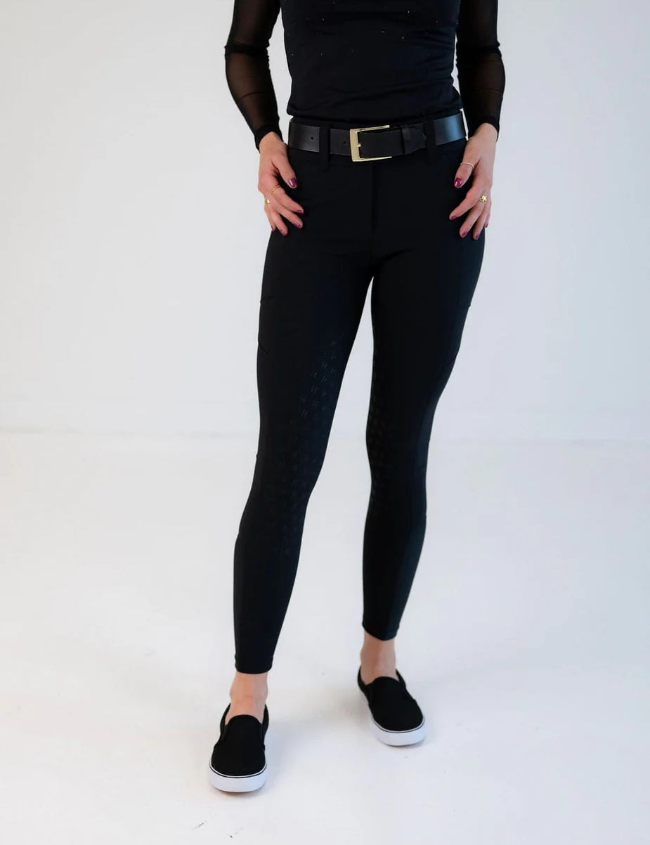 Front view of a female model wearing the black Free Ride PRO Full Seat Breeches on a plain background