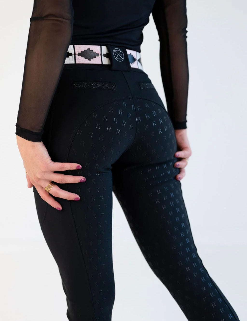 Back view of a female model wearing the black Free Ride PRO Full Seat Breeches on a plain background