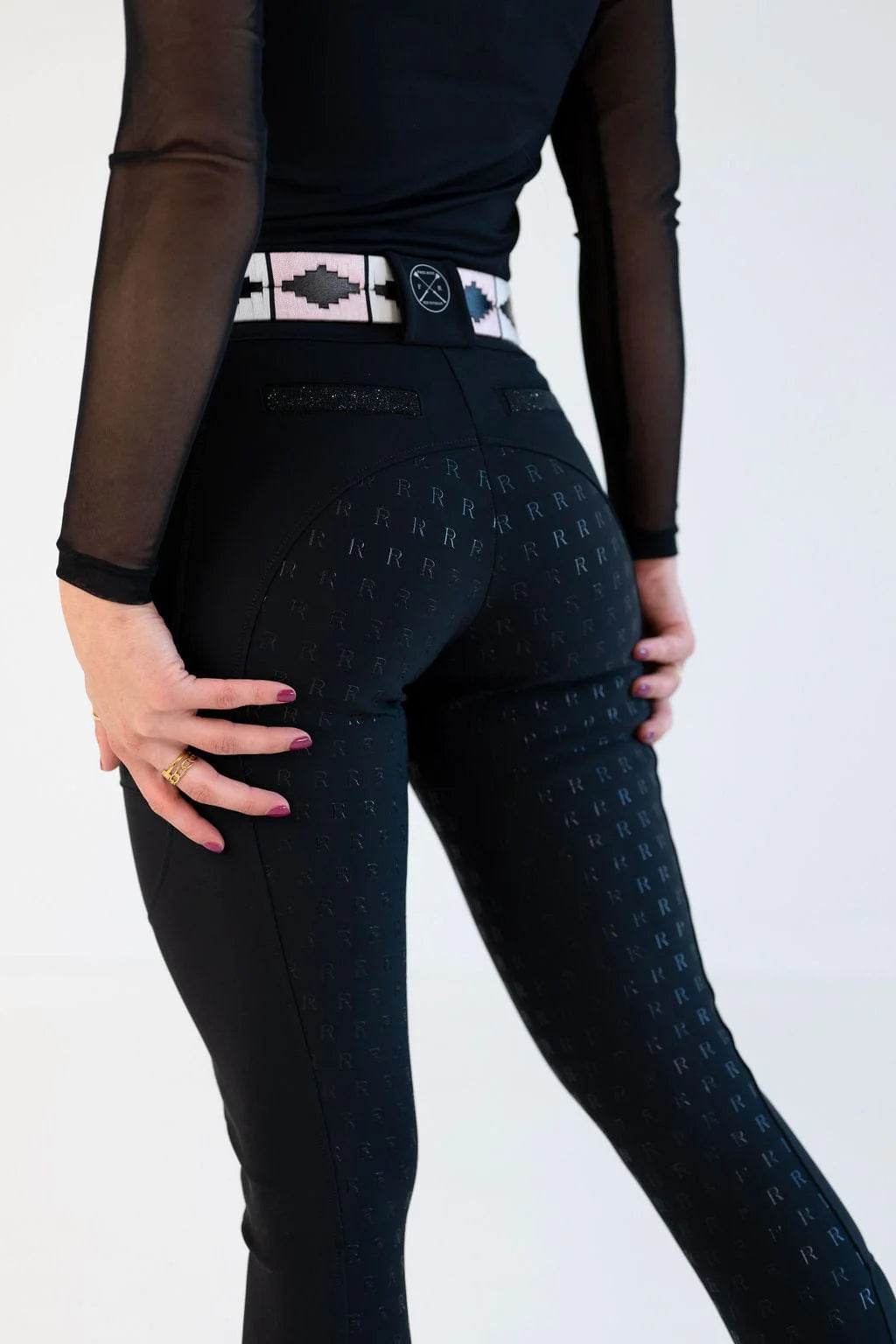 Back view of a female model wearing the black Free Ride PRO Full Seat Breeches on a plain background