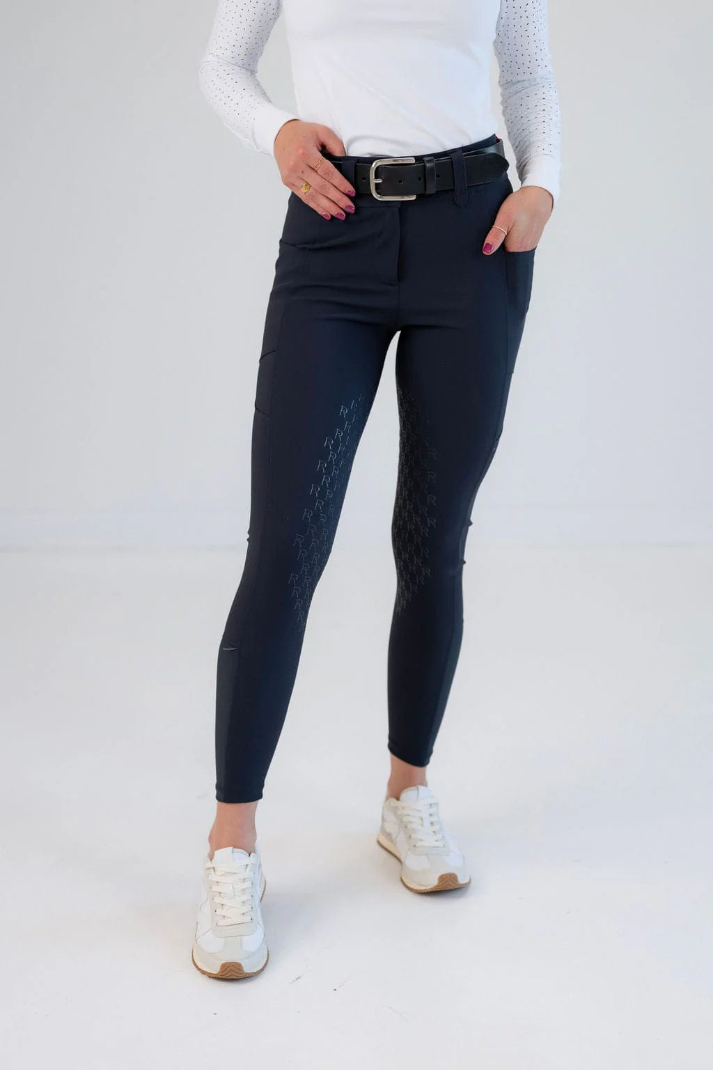 Front view of a model wearing the navy Free Ride Sparkle PRO Full Seat Breeches on a plain background