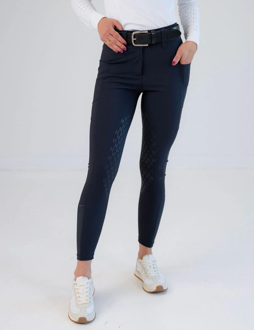 Front view of a model wearing the navy Free Ride PRO Knee Patch Breeches in a studio setting