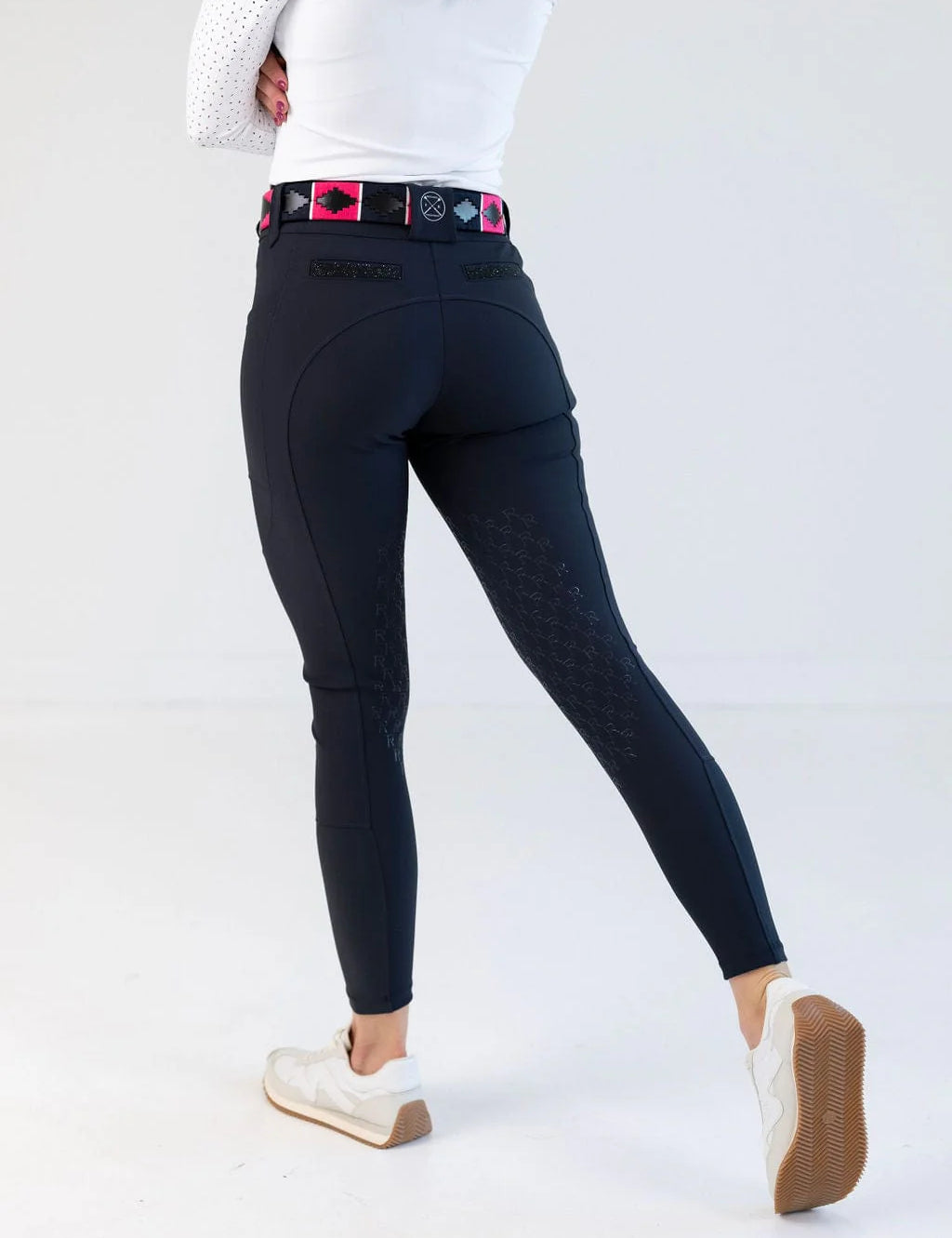 Back view of a model wearing the navy Free Ride PRO Knee Patch Breeches in a studio setting
