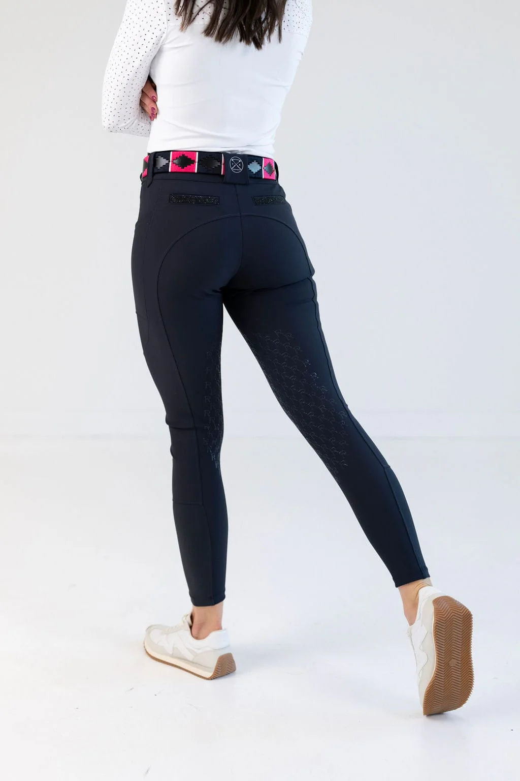 Back view of a model wearing the navy Free Ride PRO Knee Patch Breeches in a studio setting