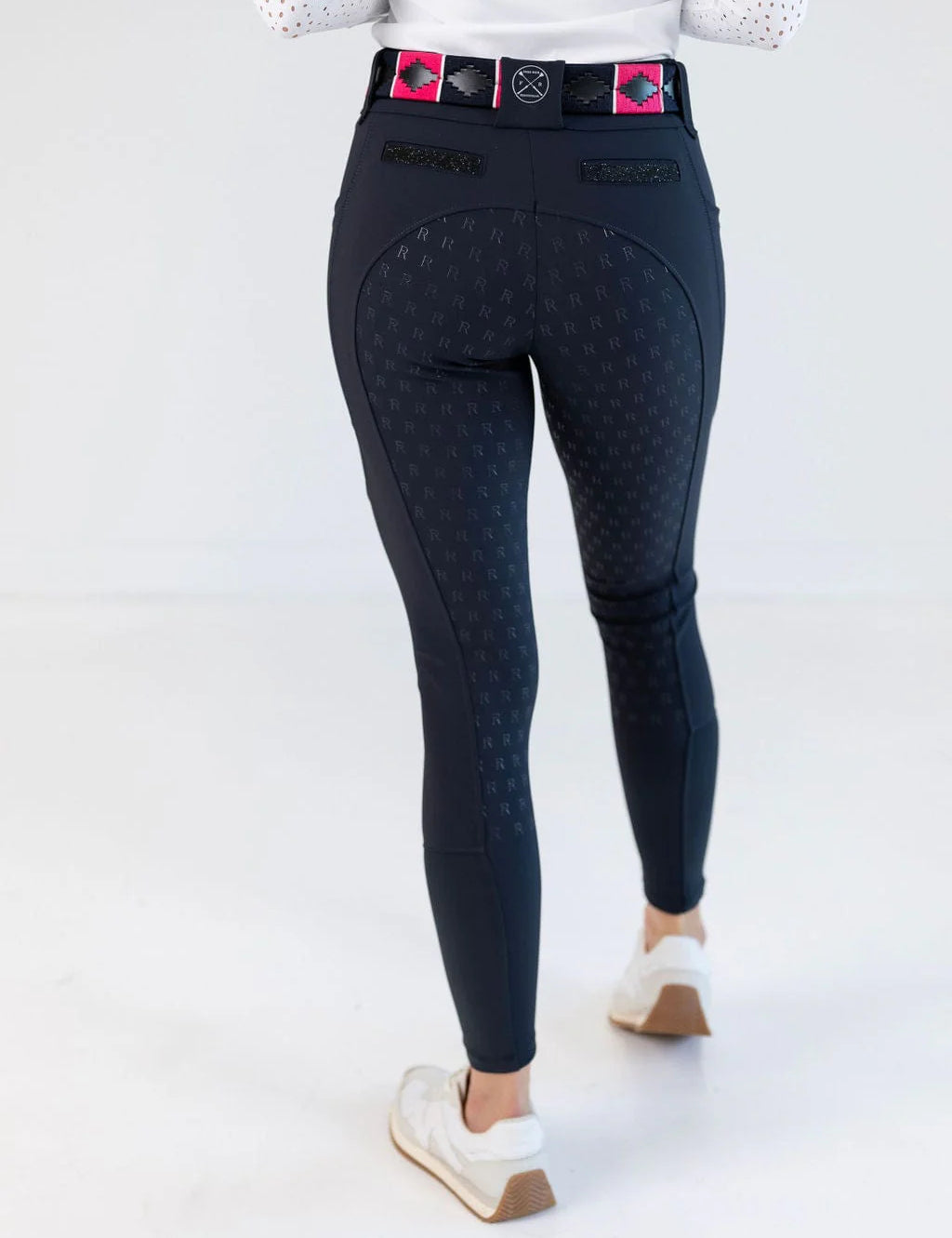 Back view of a female model wearing the navy Free Ride PRO Full Seat Breeches on a plain background