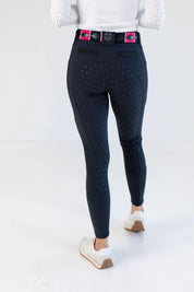 Back view of a female model wearing the navy Free Ride PRO Full Seat Breeches on a plain background