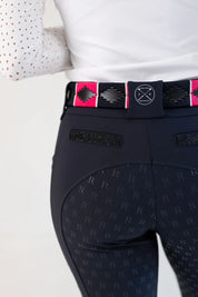 Close-up back view of the sparkles on the pockets of the navy Free Ride Sparkle PRO Full Seat Breeches on a plain background