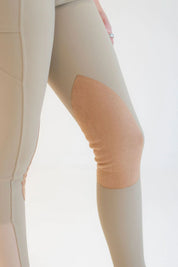 Close-up view of the suede knee patch on the beige Free Ride PRO Knee Patch Breeches on a plain background