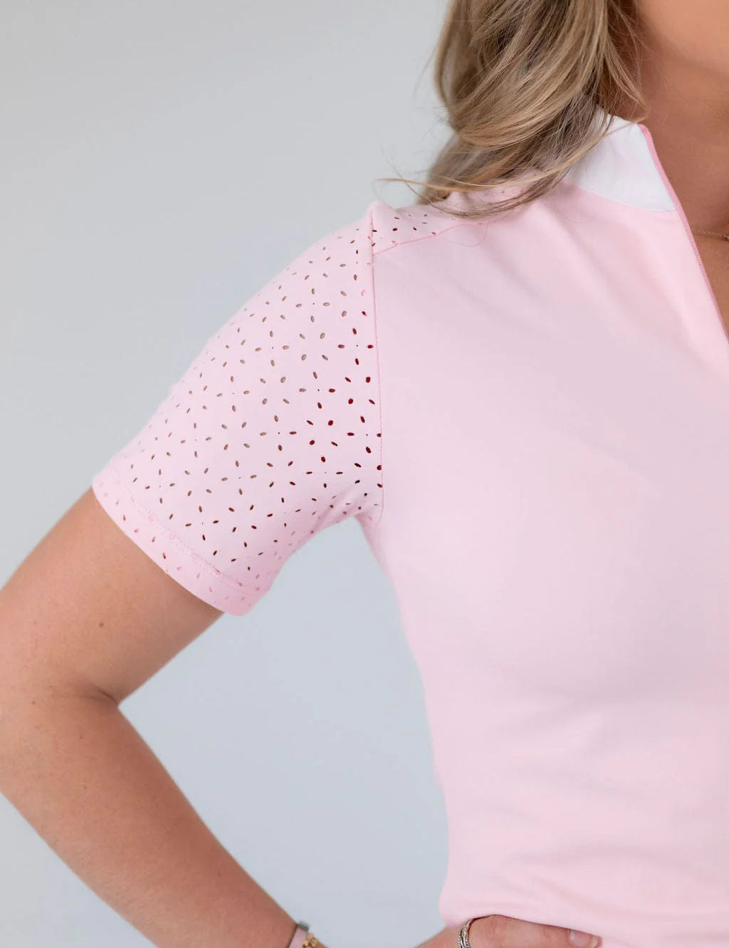 Close-up view of the laser cut perforations on the sleeve of the pink Free Ride Cassidy Short Sleeve Show Shirt