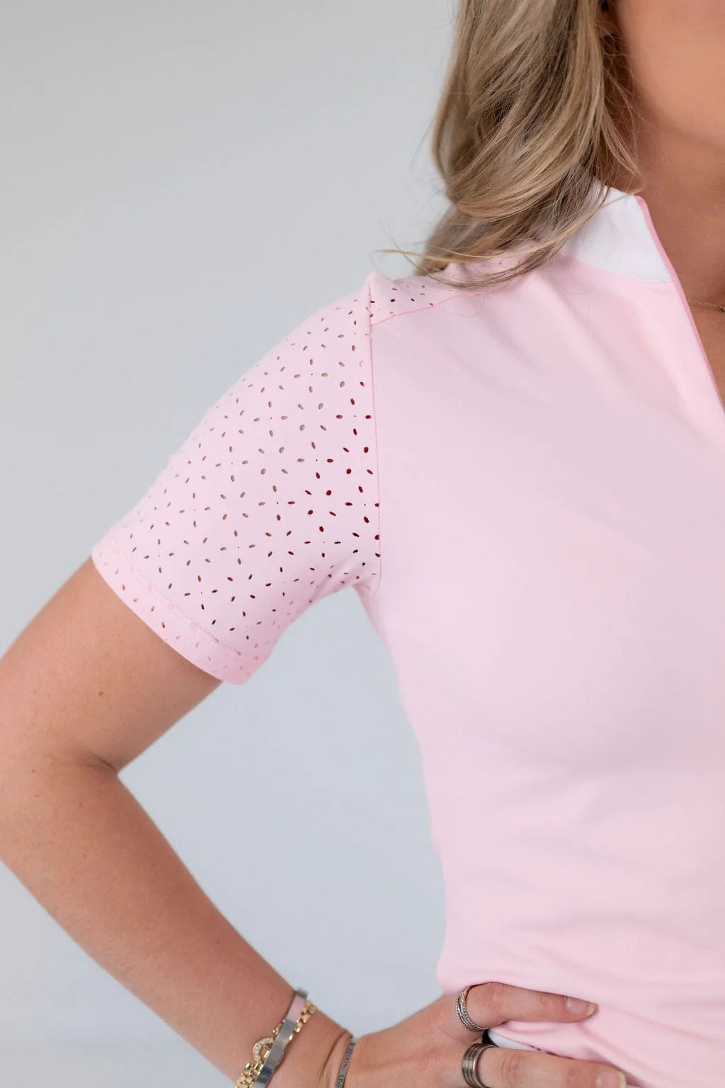 Close-up view of the laser cut perforations on the sleeve of the pink Free Ride Cassidy Short Sleeve Show Shirt