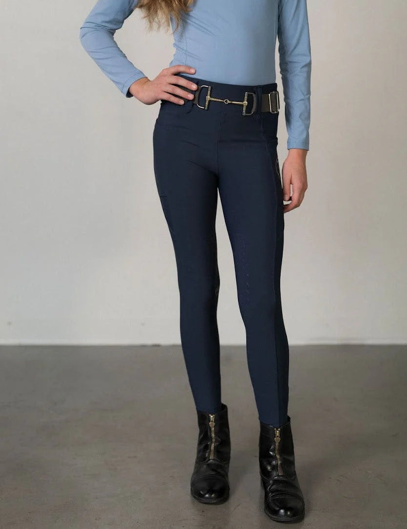 Front view of a young model wearing the navy Free Ride Youth Lux Full Seat Breeches on a plain background