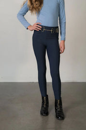 Front view of a young model wearing the navy Free Ride Youth Lux Full Seat Breeches on a plain background